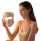 Woman inspecting a red light therapy LED face mask with visible silicone structure