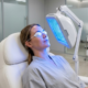 Woman receiving blue light therapy treatment in a dermatology clinic
