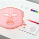 Red light therapy LED mask glowing next to specification and certification elements
